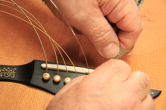 Fitting the bridge pins and strings
